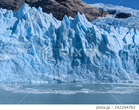 Crevassed Blue Glacier Front and Turquoise Water Close View Crevassed Blue Glacier Front and Turquoise Water Close View 142294762