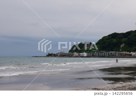 Kamakura Beach in Japan with people enjoying the sea and sandy shore 142295656