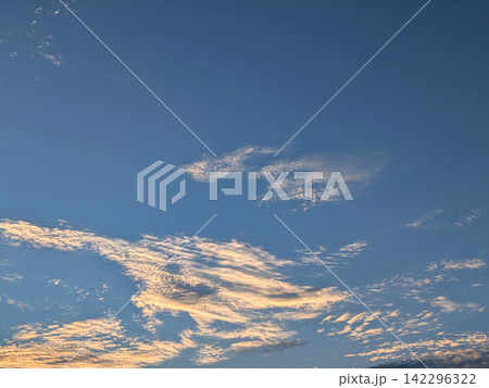 夕日に淡く染まる雲と青空 142296322