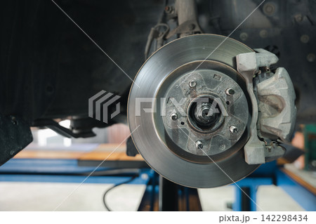 Brake system detail, high-performance caliper on car disc brakes. Automotive repair service for mechanical maintenance. 142298434