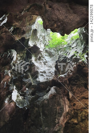 Low angle view of a dark cave exit Low angle view of a dark cave exit 142299878