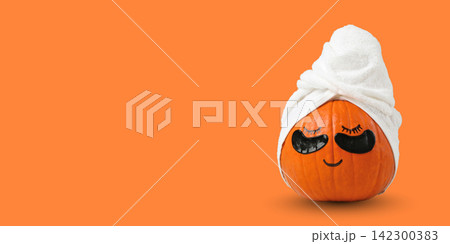 Autumn spa. Pumpkin with a towel and sunglasses promotes relaxation and fun Autumn spa. Pumpkin with a towel and sunglasses promotes relaxation and fun 142300383