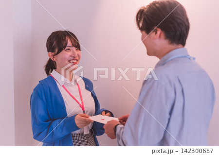 想いを込めた封筒を渡す女性のオフィスラブシーン 142300687