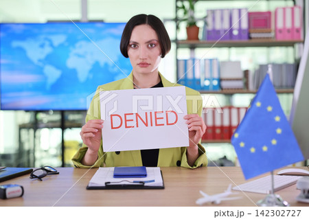 Woman displays Denied visa decision at European consular office Woman displays Denied visa decision at European consular office 142302727