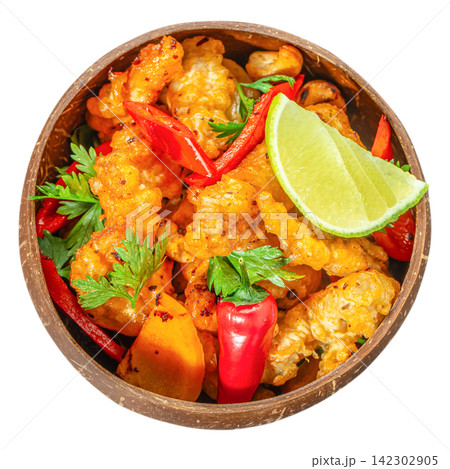 Crispy fried cauliflower with chili pepper and lime in coconut bowl isolated top view vegan appetizer Crispy fried cauliflower with chili pepper and lime in coconut bowl isolated top view vegan appetizer 142302905