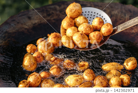 Golden Baby Potatoes Frying in Outdoor Pan Golden Baby Potatoes Frying in Outdoor Pan 142302971