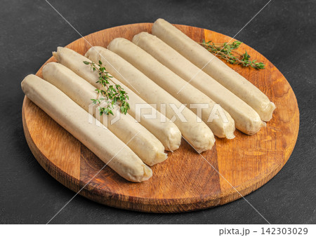 Raw White Sausages with Thyme on Wooden Board 142303029