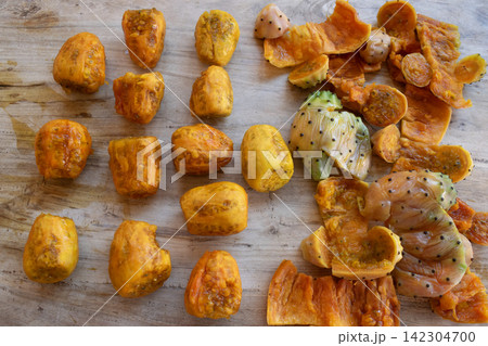 peeled prickly pears on wooden background peeled prickly pears on wooden background 142304700