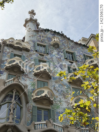 Exterior view of Casa Batllo by Antoni Gaudi in Barcelona Spain showing its colorful modernist facade and distinctive architectural details Exterior view of Casa Batllo by Antoni Gaudi in Barcelona Spain showing its colorful modernist facade and distinctive architectural details 142306170