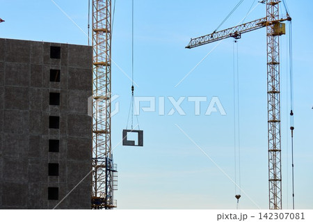 Crane hooks and steel cables against clear blue sky Crane hooks and steel cables against clear blue sky 142307081