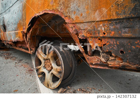 Melted Exploded Car Tire and Charred Wheel Rim Detail Melted Exploded Car Tire and Charred Wheel Rim Detail 142307132