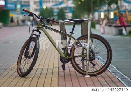 Bike Locked to Steel Rack on Urban Street Pavement Bike Locked to Steel Rack on Urban Street Pavement 142307149