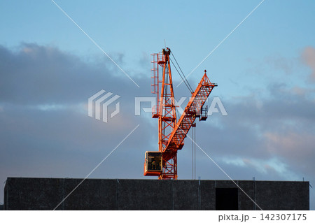 Modern residential apartment buildings under construction with cranes Modern residential apartment buildings under construction with cranes 142307175