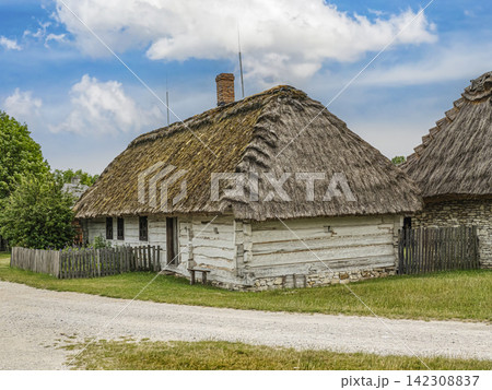Thatched Cottage in Rural Village With Whitewashed Log Walls and Traditional Thatch Roof Thatched Cottage in Rural Village With Whitewashed Log Walls and Traditional Thatch Roof 142308837
