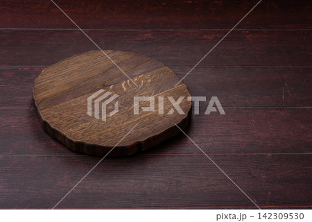 A square wooden cutting board for home food preparation. A wooden cutting board A square wooden cutting board for home food preparation. A wooden cutting board 142309530