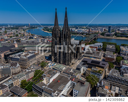 High angle wide horizontal aerial drone photograph of Cologne Cathedral, Rhine River, Hohenzollern Bridge, and city skyline in Cologne, North Rhine-Westphalia, Germany on bright sunny summer day 142309862
