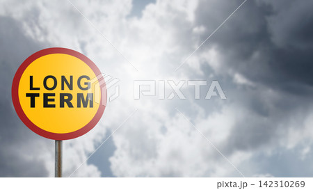 A yellow road sign with the text 'LONG TERM' set against a dramatic, cloudy sky with bright sunlight. Concept of Planning A yellow road sign with the text 'LONG TERM' set against a dramatic, cloudy sky with bright sunlight. Concept of Planning 142310269