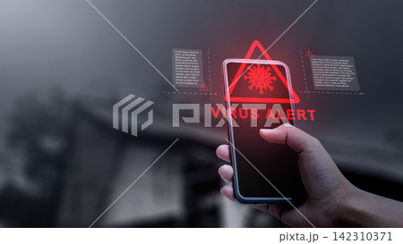 Hand holding a smartphone displaying a red holographic virus alert warning with cyber security notification. Concept of Technology Security Hand holding a smartphone displaying a red holographic virus alert warning with cyber security notification. Concept of Technology Security 142310371