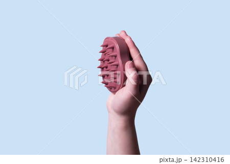 Hair and scalp massager. Device for hair care and treatment. Image for topic about hair growth and beauty salon. Copy space Hair and scalp massager. Device for hair care and treatment. Image for topic about hair growth and beauty salon. Copy space 142310416