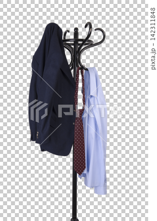 A dark blue blazer, a patterned tie, and a light blue dress shirt hang on a black coat rack. A dark blue blazer, a patterned tie, and a light blue dress shirt hang on a black coat rack. 142311848