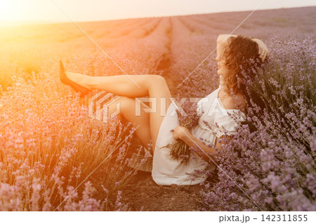 Lavender field woman sitting summer flowering plant wearing white dress relaxing in sunset sunlight during warm golden hour 142311855