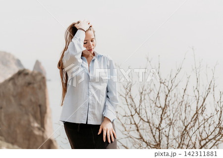 Woman nature coastal young female in blue shirt posing thoughtfully near sea cliffs with copy space in background Woman nature coastal young female in blue shirt posing thoughtfully near sea cliffs with copy space in background 142311881