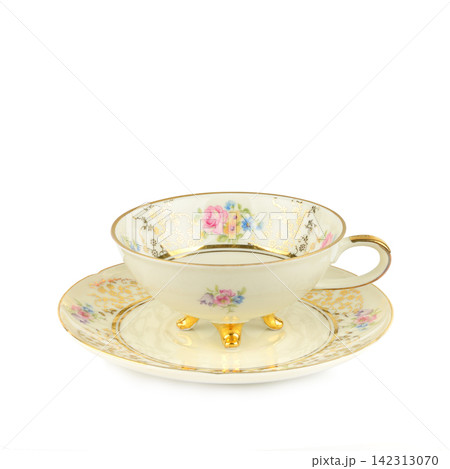 Vintage Porcelain Teacup and Saucer with Floral Pattern Isolated on White Elegant Antique China Teacup with Gold Legs and Gilded Details Vintage Porcelain Teacup and Saucer with Floral Pattern Isolated on White Elegant Antique China Teacup with Gold Legs and Gilded Details 142313070