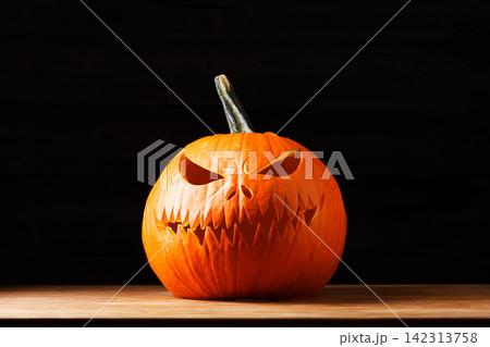 Carved Halloween pumpkin with an evil face Carved Halloween pumpkin with an evil face 142313758