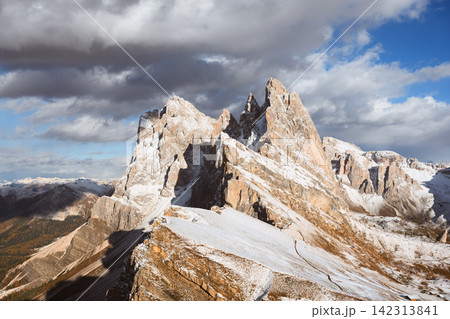 Snow-covered Seceda peaks illuminated by sunlight beneath Snow-covered Seceda peaks illuminated by sunlight beneath 142313841
