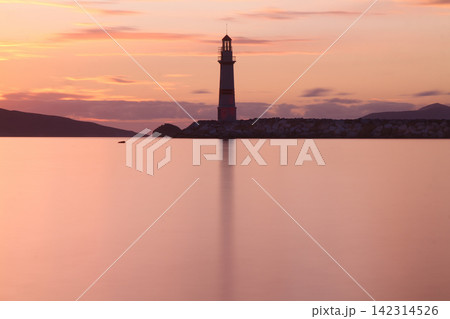 Seascape at sunshine. Lighthouse and sailings on the coast. Seaside town of Turgutreis and spectacular sunshine Seascape at sunshine. Lighthouse and sailings on the coast. Seaside town of Turgutreis and spectacular sunshine 142314526