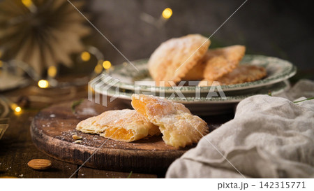 Homemade fruit filled pastries on a rustic wooden board Homemade fruit filled pastries on a rustic wooden board 142315771