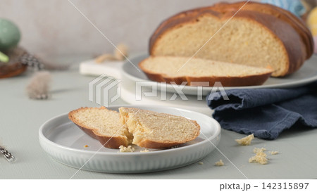 Slices of traditional Portuguese folar on white plates Slices of traditional Portuguese folar on white plates 142315897