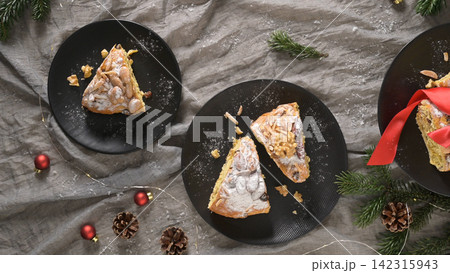 Festive Bolo Rainha slices on dark plates 142315943