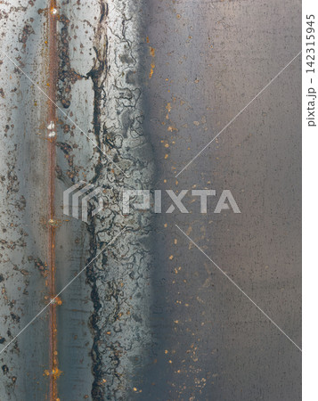 Dark Gritty Industrial Metal Surface with Rust and Weld Lines 142315945