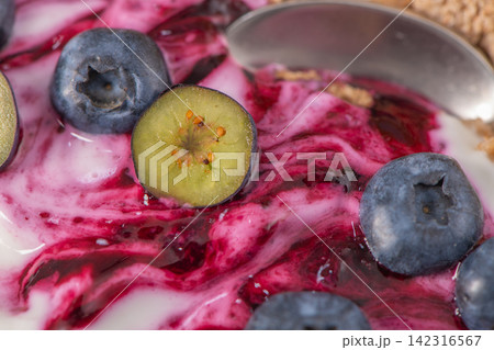 Extreme Macro Shot of Yogurt with Blueberry Compote Swirls and Slices Extreme Macro Shot of Yogurt with Blueberry Compote Swirls and Slices 142316567