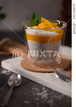 Chia Seed Pudding with Mango Puree and Fresh Mint in a Glass Chia Seed Pudding with Mango Puree and Fresh Mint in a Glass 142316679