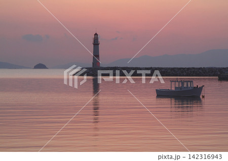 Seascape at sunshine. Lighthouse and sailings on the coast. Seaside town of Turgutreis and spectacular sunshine 142316943