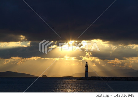 Seascape at sunshine. Lighthouse and sailings on the coast. Seaside town of Turgutreis and spectacular sunshine 142316949