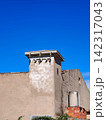 Building with electrical transformer station against blue sky 142317043