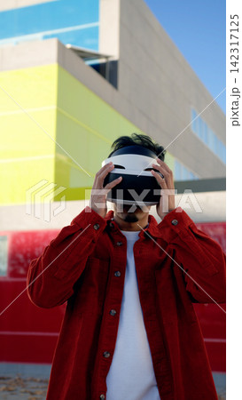 Moroccan man engaging with virtual reality metaverse Moroccan man engaging with virtual reality metaverse 142317125