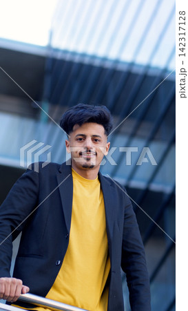 Confident Moroccan man smiling in modern urban setting Confident Moroccan man smiling in modern urban setting 142317128