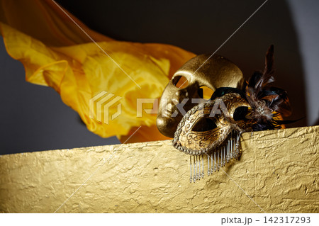Golden carnival masks on a gold background. Golden carnival masks on a gold background. 142317293