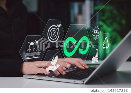 Concept of circular economy and sustainable business, a person using a laptop with icons for renewable energy, recycling, carbon reduction, eco goals, green industry and environmental responsibility. Concept of circular economy and sustainable business, a person using a laptop with icons for renewable energy, recycling, carbon reduction, eco goals, green industry and environmental responsibility. 142317858