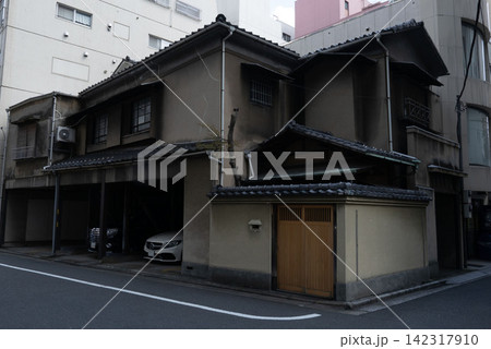 都市開発の中で生き残る伝統的な日本家屋、過去と現在が同居するストリートスナップ 都市開発の中で生き残る伝統的な日本家屋、過去と現在が同居するストリートスナップ 142317910