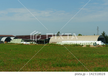 Scenic rural landscape of green fields and farms under a bright sky Scenic rural landscape of green fields and farms under a bright sky 142318028