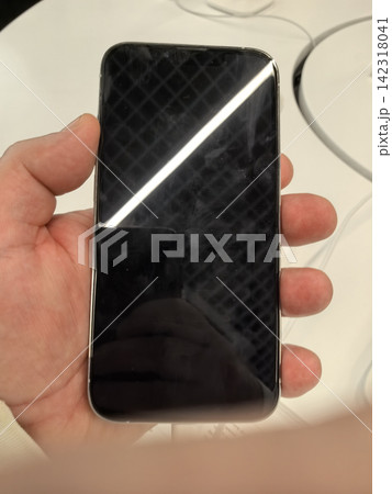 Exploring the sleek design of a modern smartphone in a bright setting Exploring the sleek design of a modern smartphone in a bright setting 142318041