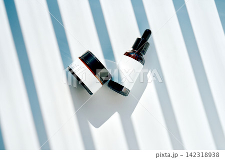 Skincare product bottles with blank labels and shadow stripes Skincare product bottles with blank labels and shadow stripes 142318938