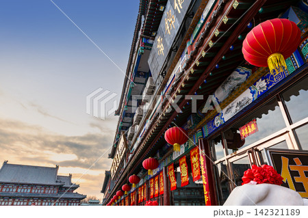 classical Chinese wooden architectural building with traditional tile roof under blue sky 142321189