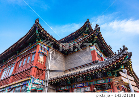classical Chinese wooden architectural building with traditional tile roof under blue sky 142321191
