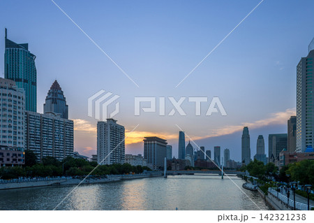 city skyline and skyscrapers along Haihe River at twilight in Tianjin China 142321238